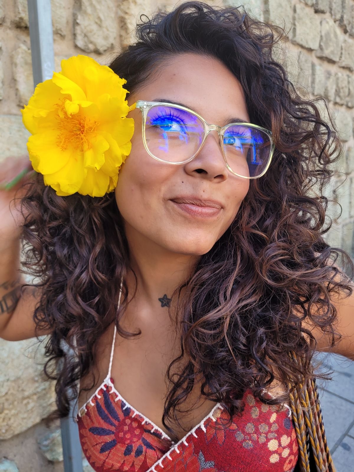 Carol with a yellow flower tucked behind her ear